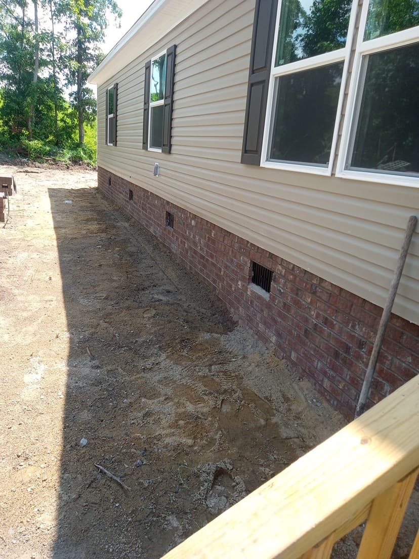 Side view of completed brick skirt showing quality workmanship from multiple angles