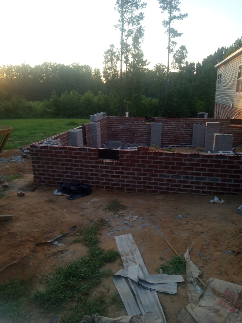 Large-scale brick foundation wall construction showing expert masonry skills and quality materials